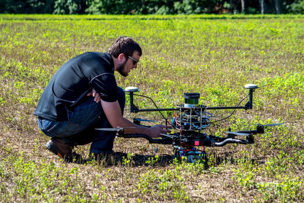 A SkySpecs technician tends to a drone prior to a wind-turbine blade inspection.