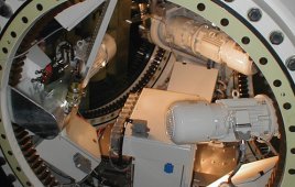 A view inside the hub, before a blade goes on, shows three pitch motors on gearboxes. Ultracapacitors are inside the three smaller enclosures. The large enclosure (center) holds controls.